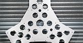 close up of steel part with holes